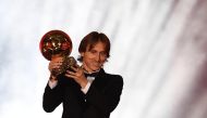 Real Madrid's Croatian midfielder Luka Modric brandishes the trophy after receiving the 2018 FIFA Men's Ballon d'Or award for best player of the year during the 2018 FIFA Ballon d'Or award ceremony at the Grand Palais in Paris on December 3, 2018.  AFP / 