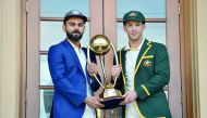 Australia cricket captain Tim Paine (R) and India cricket captain Virat Kohli (L) pose with the Border Gavaskar trophy ahead of the first Test at the Adelaide Oval in Adelaide on December 5, 2018. AFP / Peter Parks