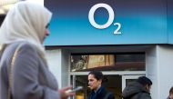 In this file photo taken on January 23, 2015 People walk past a branch of an O2 store in central London on Janurary 23, 2015.  / AFP / Justin TALLIS 
