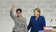 Annegret Kramp-Karrenbauer (L) greets delegates while she stands next to German Chancellor Angela Merkel (R) after Kramp-Karrenbauer has been elected as new party leader during the 31st Party Congress of the Christian Democratic Union (CDU) at a congress 