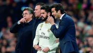 Real Madrid's Argentinian coach Santiago Solari speaks to Real Madrid's Spanish midfielder Isco before he enters into the pitch during the Spanish league football match between Real Madrid and Valencia at the Santiago Bernabeu stadium in Madrid on Decembe
