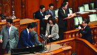 Parliament members of the ruling party vote during a plenary session of the upper house at parliament in Tokyo on December 7, 2018.  AFP / Kazuhiro Nogi

