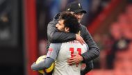 Liverpool's Egyptian midfielder Mohamed Salah (L) holding the match-ball for scoring a hat-trick is embraced by Liverpool's German manager Jurgen Klopp (R) on the pitch after the English Premier League football match between Bournemouth and Liverpool at t