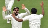  India's captain Virat Kohli (L) celebrates with spin bowler Ravichandran Ashwin (R) after beating Australia on day five of the first Test cricket match at the Adelaide Oval on December 10, 2018. / AFP / PETER PARKS
