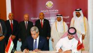 Minister of Commerce and Industry H E Ali bin Ahmed Al Kuwari and Dr. Mohammed Hashim Abdul Majeed Al Ani, Iraq’s Minister of Trade, witness the signing of an agreement in Doha yesterday.