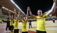 Dortmund players celebrate at the end of the UEFA Champions League Group A football match between Monaco and Dortmund at the Louis II stadium in Monaco, on December 11, 2018. / AFP / VALERY HACHE