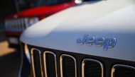FILE PHOTO: In this file photo taken on August 21, 2017 a car dealer in Turin shows the logos of Jeep, brands of Fiat Chrysler Automobiles (FCA).  AFP / Marco BERTORELLO

