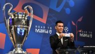 Former Spanish player Luis Garcia shows the slip of Bayern Munchen next to the Cup during the draw for the UEFA Champions League last-16 in Nyon, yesterday. 
