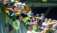 Australia's cricketer Mitchell Starc takes a selfie with fans during day five of the second cricket match between Australia and India in Perth on December 18, 2018. AFP / William West