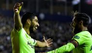 Barcelona's Uruguayan forward Luis Suarez (L) celebrates a goal with Barcelona's Argentinian forward Lionel Messi during the Spanish League football match between Levante and Barcelona at the Ciutat de Valencia stadium in Valencia on December 16, 2018. / 