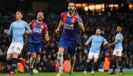 Crystal Palace's Serbian midfielder Luka Milivojevic (C) celebrates scoring their third goal from the penalty spot to extend their lead 1-3 during the English Premier League football match between Manchester City and Crystal Palace at the Etihad Stadium i