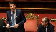 Italian Prime Minister Giuseppe Conte speaks about the government's 2019 budget, next to Italian Economy Minister Giovanni Tria, during a debate at the Senate in Rome, Italy, December 19, 2018. REUTERS/Tony Gentile