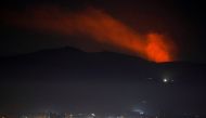 Smoke rises past a mountain as seen from Damascus countryside, Syria December 25, 2018. REUTERS/Omar Sanadiki
