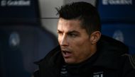 Juventus' Portuguese forward Cristiano Ronaldo looks on from the substitutes' bench prior to the Italian Serie A football Match Atalanta Bergamo vs Juventus on December 26, 2018 at the Atleti Azzurri d'Italia stadium in Bergamo. / AFP / Marco BERTORELLO
