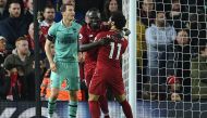 Liverpool's Senegalese striker Sadio Mane (C) celebrates scoring his team's third goal with Liverpool's Egyptian midfielder Mohamed Salah (R) during the English Premier League football match between Liverpool and Arsenal at Anfield in Liverpool, north wes