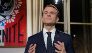 French President Emmanuel Macron gestures as he delivers his New Year wishes during a televised address to the nation from the Elysee Palace in Paris on December 31, 2018. / AFP / POOL / Michel Euler