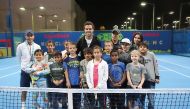 Italian star Marco Cecchinato poses for photograph along with children who took part at a Kids Tennis Clinic in Doha, yesterday. 