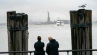 People watch as the Statue of Liberty and Ellis Island ferry transports passengers in New York in this file photo taken on January 5, 2019, as the US government shutdown enters its third week, but New York funds are keeping the Ellis Island and Liberty Pa