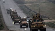 (FILES) In this file photo taken on December 30, 2018 a convoy of US military vehicles rides in Syria's northern city of Manbij. AFP / Delil SOULEIMAN