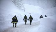 Firefighters walk at the valley station of the Hochkar cable car at 1380 m altitude on January 13, 2019 in Hochkar.  / ALEX HALADA / AFP