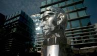 A pedestrian walks past the statue of a giant rotating head of writer Franz Kafka by Czech artist David Cerny on July 26, 2016 in Prague. AFP/Michal Cizek