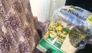 Adja Aissata Aya Ndiaye, 62, a farmer in Kedougou in southern Senegal, holds a bag of fonio she has produced, Nov. 30, 2018. Thomson Reuters Foundation/Emmanuelle Landais