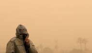 A man covers his face during a sandstorm in Cairo, Egypt January 16, 2019. Mohamed Abd El Ghany \ REUTERS .