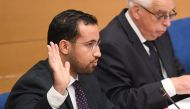 In this file photo taken on September 19, 2018 Former Elysee senior security officer Alexandre Benalla raises his hand as he takes the oath before a Senate committee in Paris.  AFP / Alain Jocard
 
