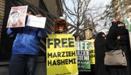 Iranians hold banners bearing messages that call for the release of US-born journalist Marzieh Hashemi, in front of the Swiss embassy in the capital Tehran on January 20, 2019. (AFP / ATTA KENARE)