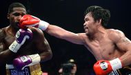 Manny Pacquiao (black trunks) and Adrien Broner (purple/gold trunks) box during a WBA welterweight world title boxing match at MGM Grand Garden Arena. Credit: Joe Camporeale-USA TODAY Sports