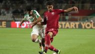 Qatar's forward Akram Afif (R) is marked by Iraq's defender Alaa Ali Mhawi during the 2019 AFC Asian Cup Round of 16 football match between Qatar and Iraq at the Al Nahyan Stadium in Abu Dhabi on January 22, 2019. / AFP / Karim Sahib
