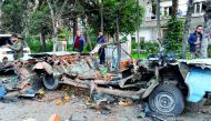  Aandout picture released by the official Syrian Arab News Agency (SANA) on January 24, 2019 shows people looking at the remains of a car which exploded following a bomb attack near the Russian embassy in the Syrian capital Damascus. Via AFP