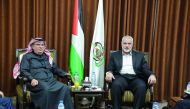 Hamas Chief Ismail Haniyah (right), meets with Qatari envoy Mohammed Al Emadi in Gaza City, yesterday.