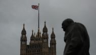 The Victoria tower of the Palace of Westminster that house the Houses of Parliament is seen next to a statue of Former British Prime Minister Winston Churchill in Westminster in central London on January 26, 2019. AFP / Daniel LEAL-OLIVAS