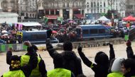 People wearing Yellow vests gestures as French 'red scarves' (foulards rouges), critics of violent 'yellow vest' (Gilets Jaunes) protest in Paris on January 27, 2019. AFP / Alain Jocard 