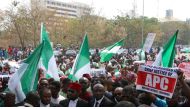 Nigerian lawyers and protesters, some holding up the national flag, gather outside the secretariat of the Nigerian Bar Association during a protest in Abuja over the suspension of Chief Justice of Nigeria (CJN) in Abuja on January 28, 2019. AFP / SODIQ AD
