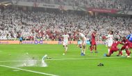 Fans throw bottles and flip-flops at the pitch during the 2019 AFC Asian Cup semi-final football match between Qatar and UAE at the Mohammed Bin Zayed Stadium in Abu Dhabi on January 29, 2019. / AFP / Giuseppe CACACE