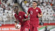 Qatar's forward Almoez Ali (L) celebrates his goal during the 2019 AFC Asian Cup semi-final football match between Qatar and UAE at the Mohammed Bin Zayed Stadium in Abu Dhabi on January 29, 2019. (AFP / Roslan RAHMAN)