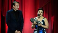 Film producers Gabriela Rodriguez (R) and Nicolas Celis receive the best Latin-American film award for the Mexican film 'Roma' at the 33rd Goya awards ceremony in Seville on February 2, 2019. / AFP / JAVIER SORIANO