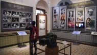 In this picture taken on January 22, 2019, a student takes a picture of a display with images of former Indian movie actors at the National Museum of Indian Cinema (NMIC), the country's first museum showcasing the history of its film industry, in Mumbai. 
