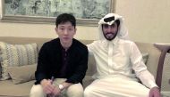 Nam Tae-hee (left) and Al Sadd SC’s General Manager, Turki Al Ali pose for a photograph after signing a three-year deal in Doha, yesterday.