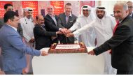 Officials of Jumbo Electronics and Ooredoo during a cake cutting ceremony.