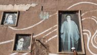 A Muslim Shiite cleric walks past the house of the late founder of the Islamic Republic, Ayatollah Ruhollah Khomeini, in the holy city of Qom, 130 kilometres south of Tehran on January 15, 2019.  / AFP / ATTA KENARE 