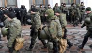 Police officer stand guard as activists call for the deputies to recognise Russia as an aggressor state during a rally in front of the Ukrainian parliament in Kiev on January 16, 2018. AFP/Sergei Supinsky