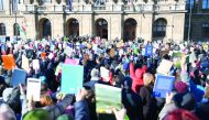 People hold up books as they protest against the education and scientific research policy of the Hungarian government in front of the Hungarian Academy of Sciences in Budapest on February 12, 2019. AFP / Attila Kisbenedek

