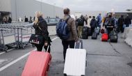 Passengers leave Brussels national airport in Zaventem, on the outskirts of the Belgium capital, on February 13, 2019, during a national general strike. Belgium OUT / AFP / BELGA / THIERRY ROGE