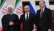A handout picture taken and released on February 14, 2019 by the Turkish Presidential Press service shows Iranian President Hassan Rouhani (L), Russian President Vladimir Putin (C) and Turkish President Recep Tayyip Erdogan (R) posing for photographers du