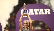 Belgian Elise Mertens poses with the trophy after her victory over Romanian Simona Halep in their WTA Qatar Open final tennis match in Doha on February 16, 2019. / AFP / KARIM JAAFAR