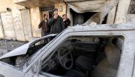 Syrian men look at the destroyed house of their neighbour in the rebel-held town of Maaret al-Numan in the north of Idlib province on February 18, 2019, following reported shelling by government forces. / AFP / OMAR HAJ KADOUR