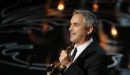 Alfonso Cuaron accepts the Oscar for best director for Gravity at the 86th Academy Awards in Hollywood, March 2, 2014. Reuters/Lucy Nicholson